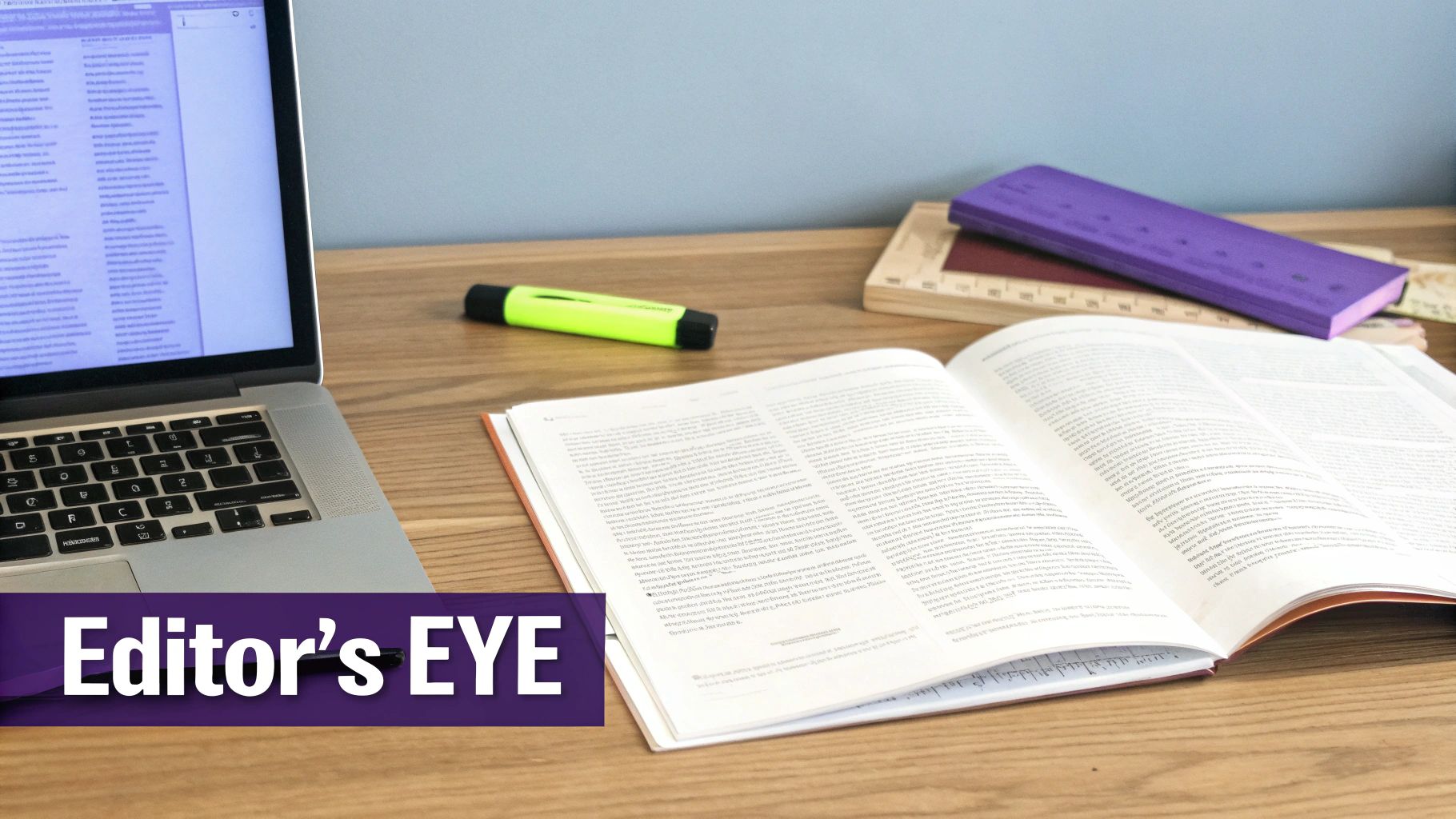 A bright workspace showing an open laptop, an open book, a highlighter, and office supplies.