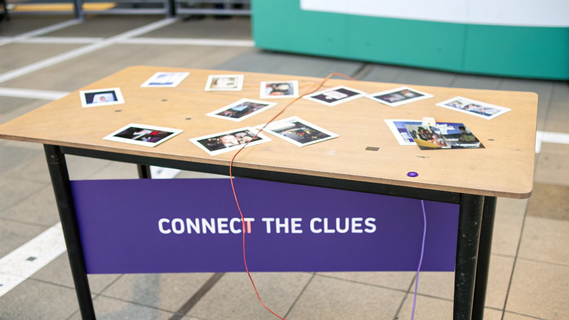 A wooden table displays polaroid photos and wires, with a banner stating 'CONNECT THE CLUES'.