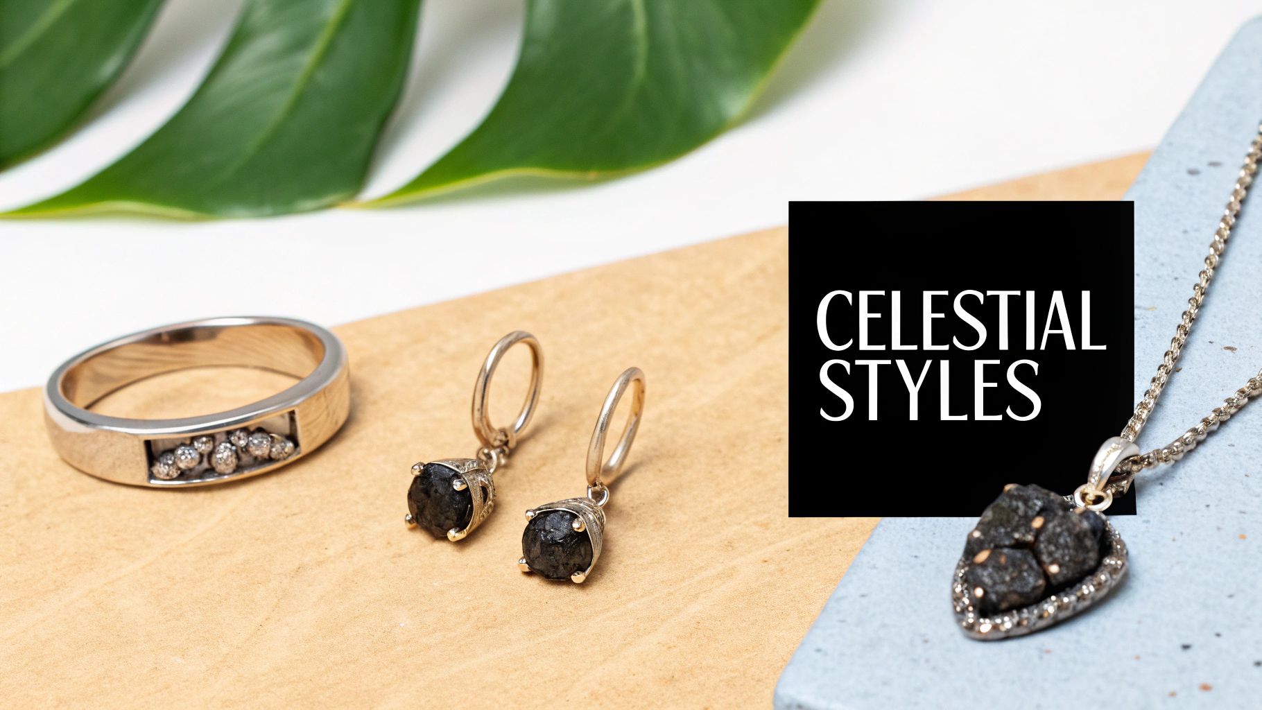 A collection of celestial-themed jewelry, including a silver ring with diamonds, black gemstone earrings, and a heart-shaped pendant.