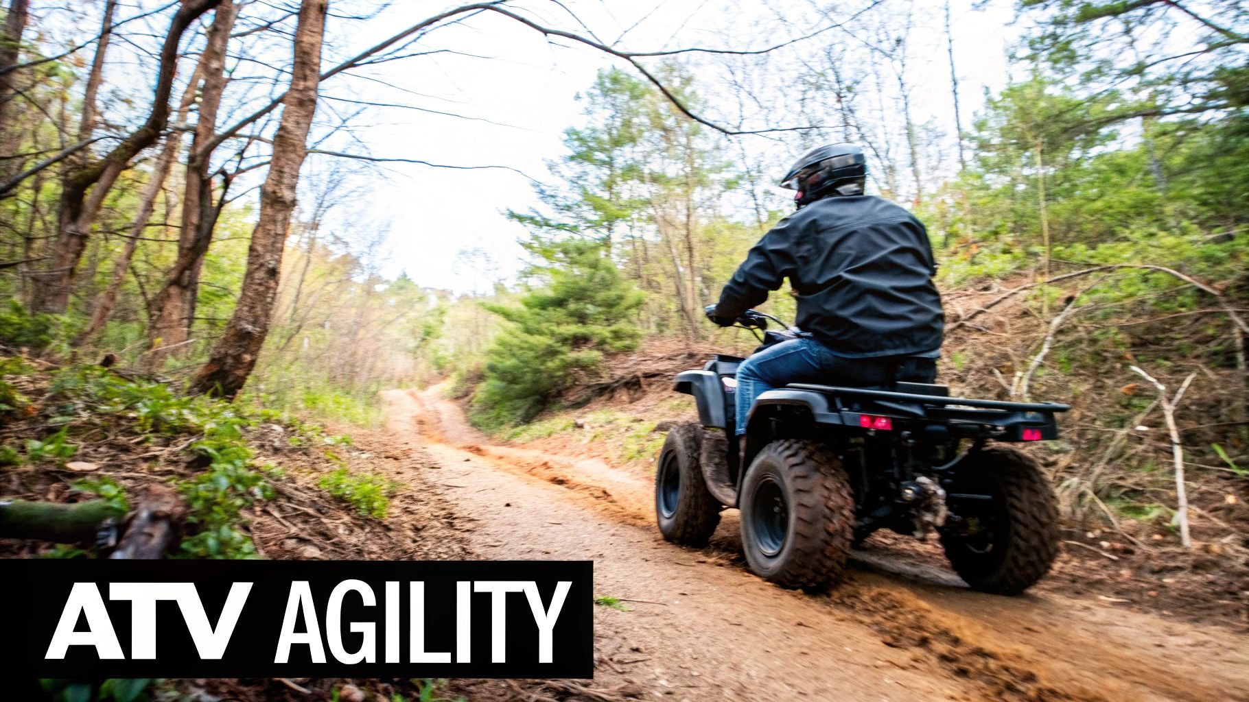 A person riding an All-Terrain Vehicle through a wooded trail