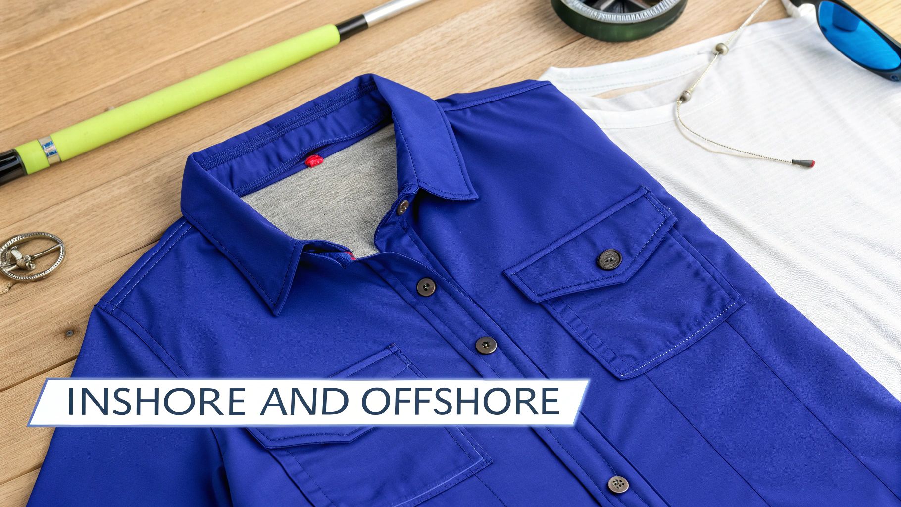 A blue long-sleeve shirt and white t-shirt with fishing gear on wood, featuring "INSHORE AND OFFSHORE".