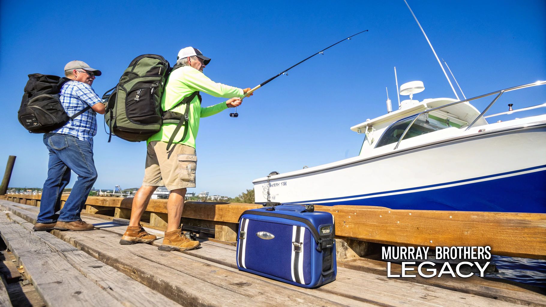 Two men carrying backpacks and fishing gear on a wooden dock beside a white boat.