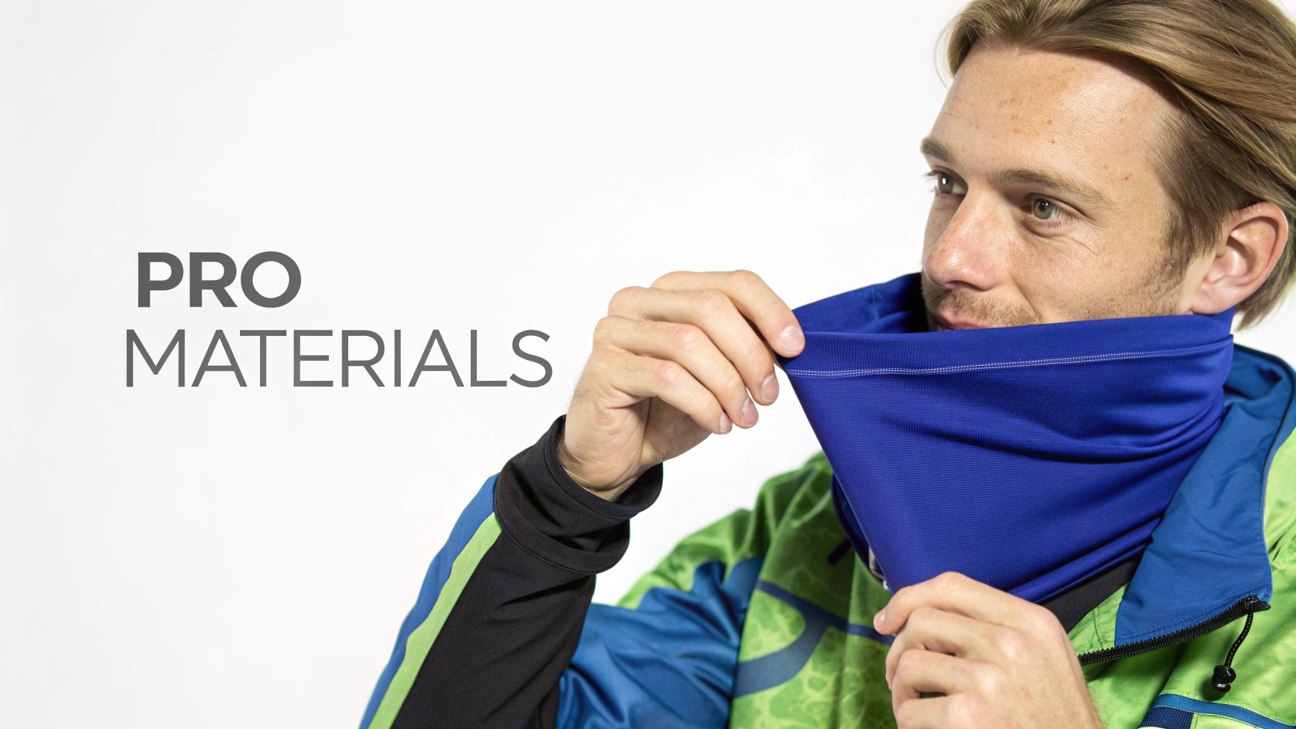 A man wearing a green and blue jacket adjusts a blue neck gaiter, showcasing 'PRO MATERIALS'.