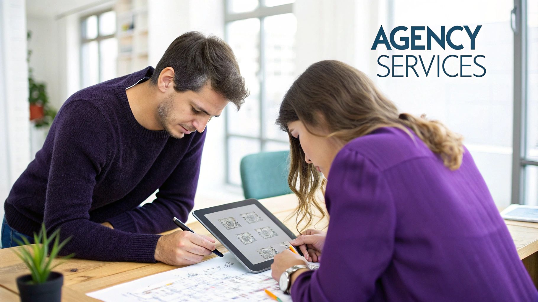 A man and a woman collaborating on a creative project with a tablet and documents.