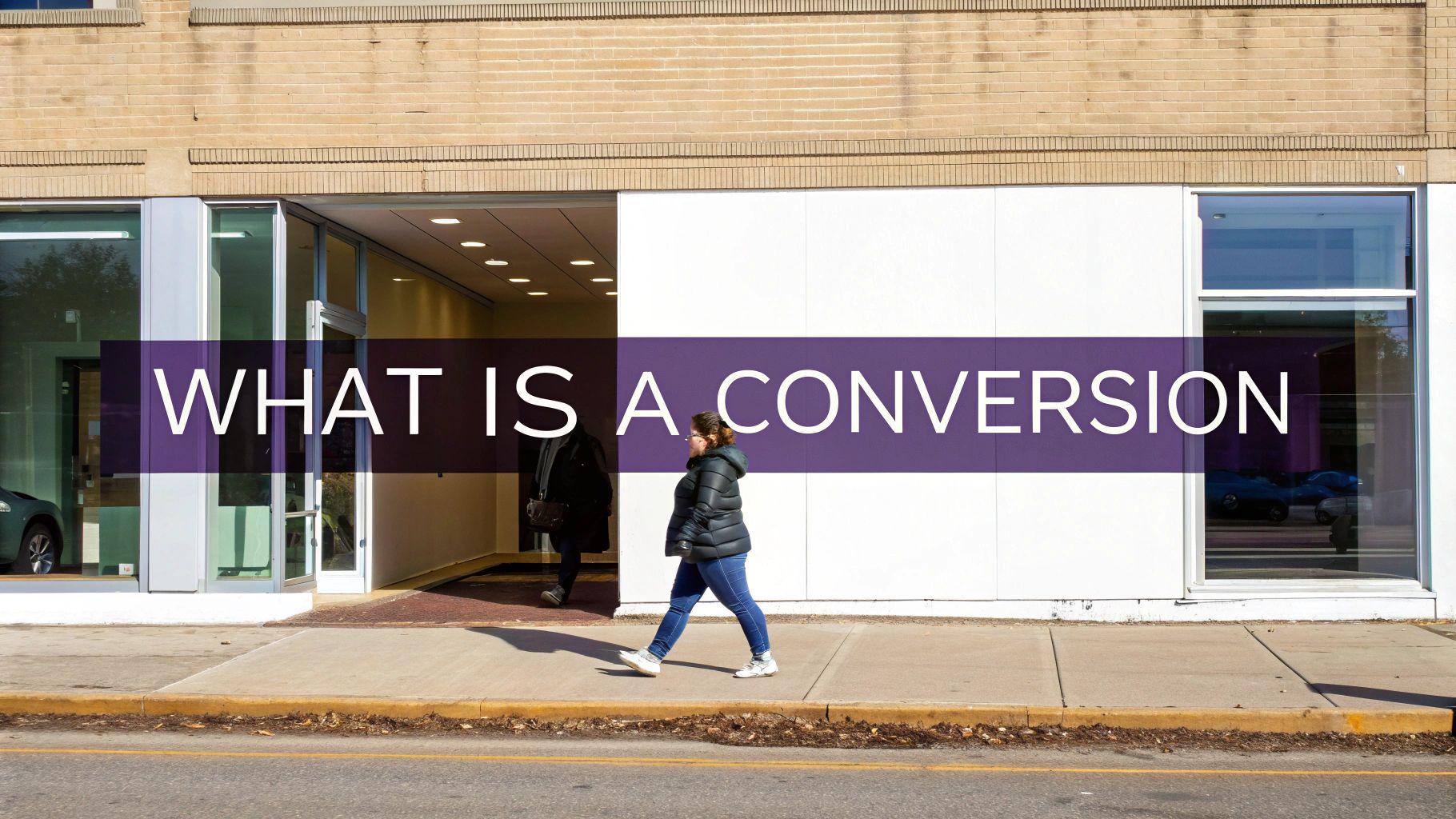 A woman walks past a modern storefront with a large purple banner reading 'WHAT IS A CONVERSION'.