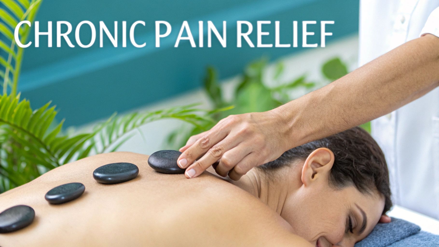 A therapist places hot stones on a client's back for chronic pain relief.