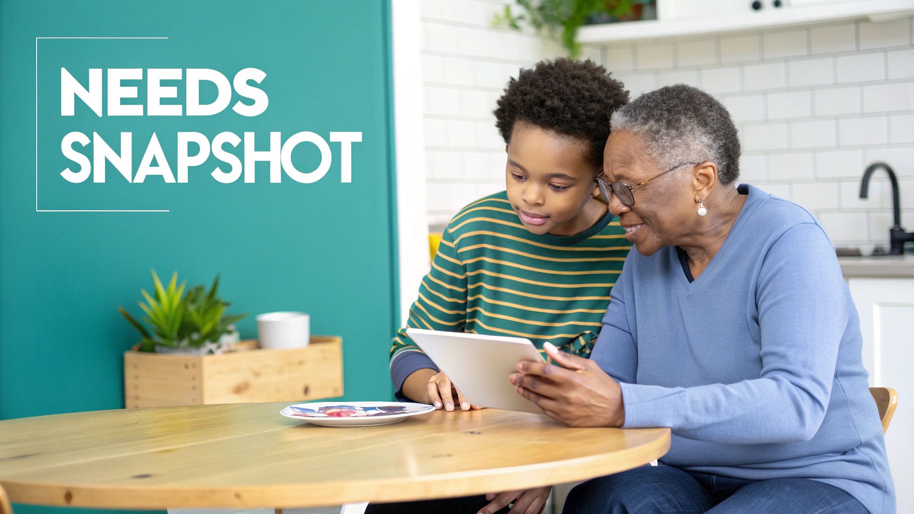 An elderly woman and a young boy sit at a table, looking at a tablet together.