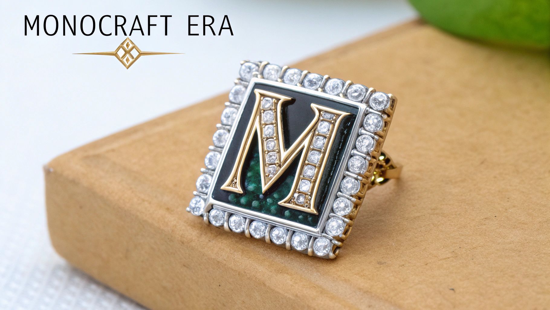 A close-up of a gold ring featuring an initial 'M' surrounded by diamonds, on a wooden surface.