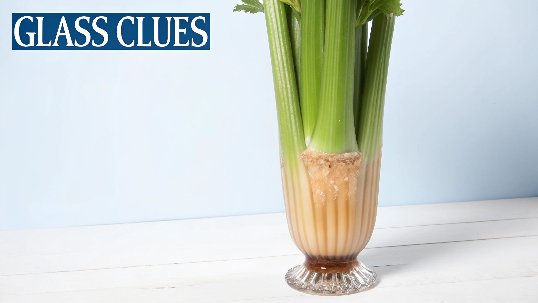 A fresh celery bunch with green stalks sits in a clear ribbed glass vase with water.