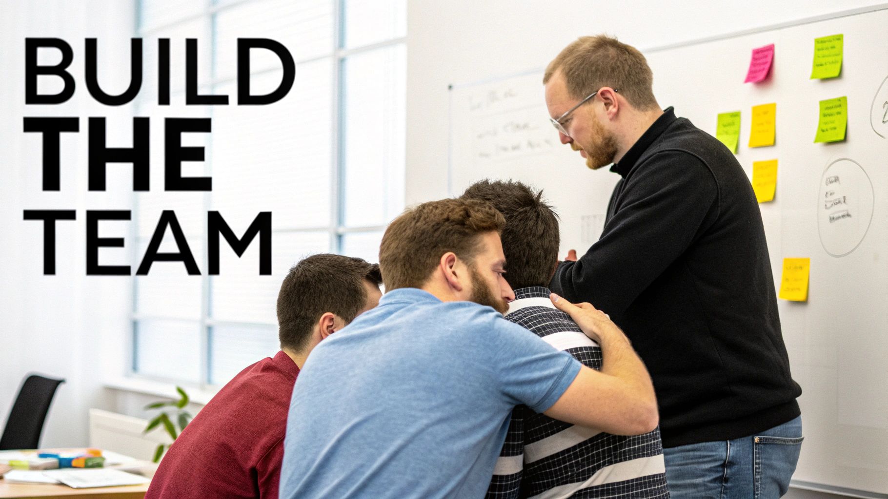 A team of men collaborating around a whiteboard with sticky notes and text 'BUILD THE TEAM'.