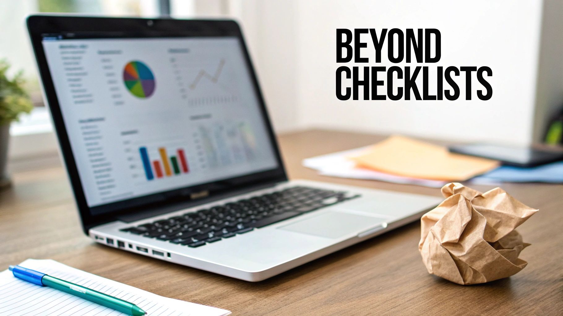 Laptop displaying charts and graphs, with a pen, notebook, and crumpled paper on a desk. Text: BEYOND CHECKLISTS.