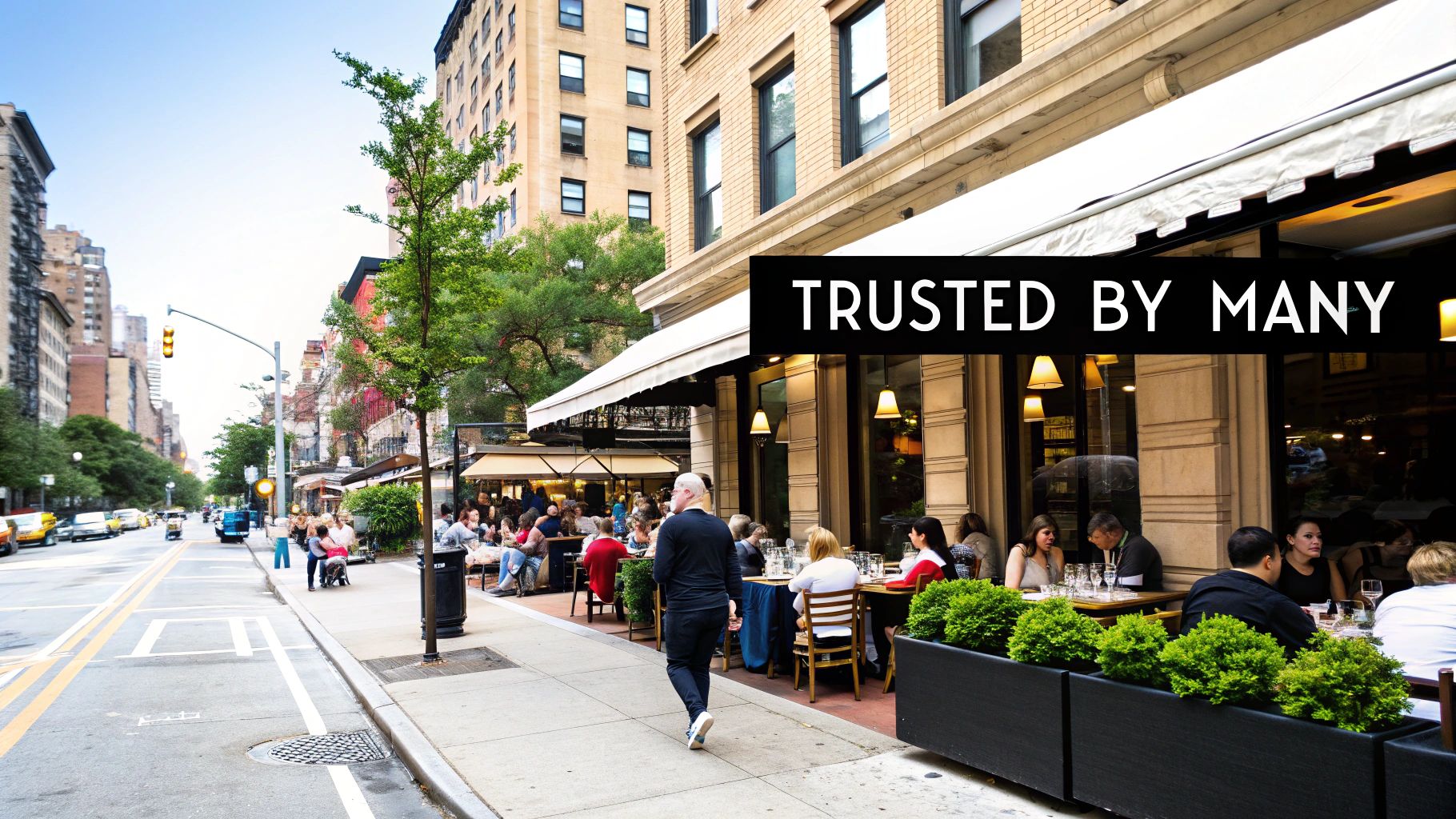Customers enjoying outdoor dining at a lively restaurant on a city street, illustrating social proof.