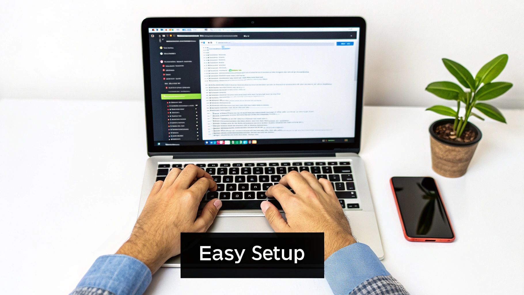 A person's hands are typing on a laptop displaying a chat widget, with a phone and plant on a white desk.