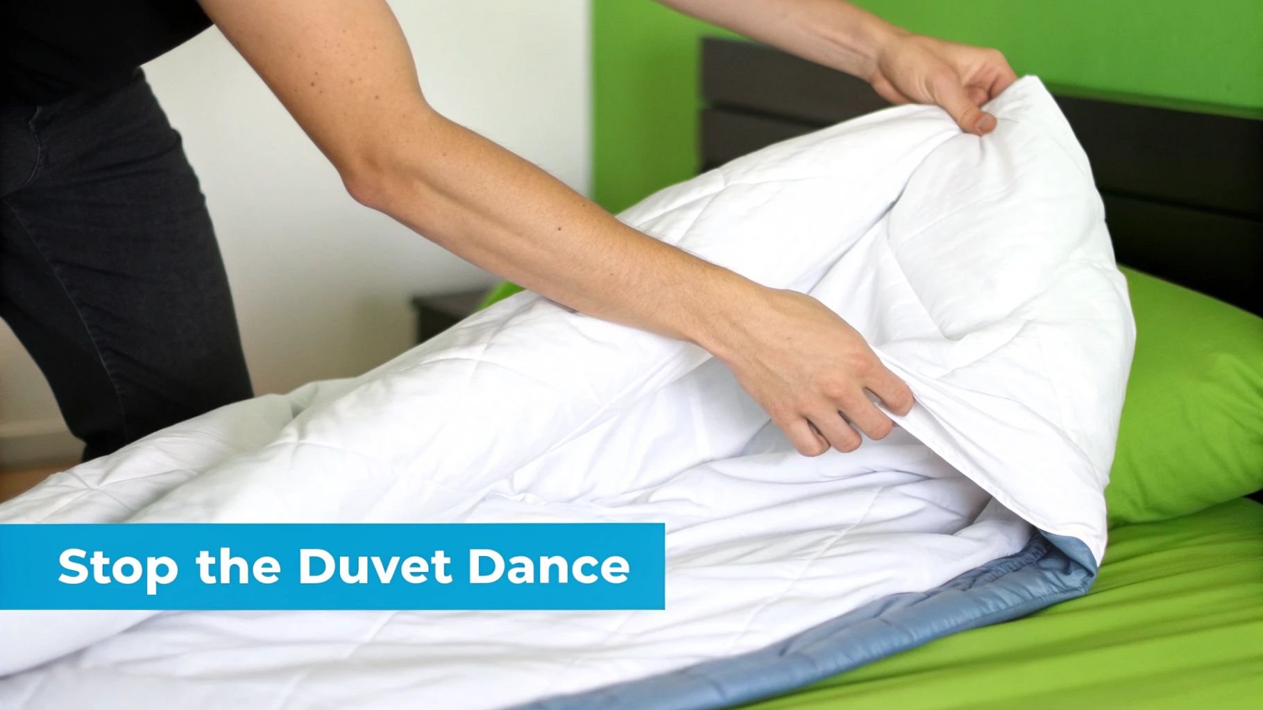 A person's hands are adjusting a white quilted duvet cover on a green bed.
