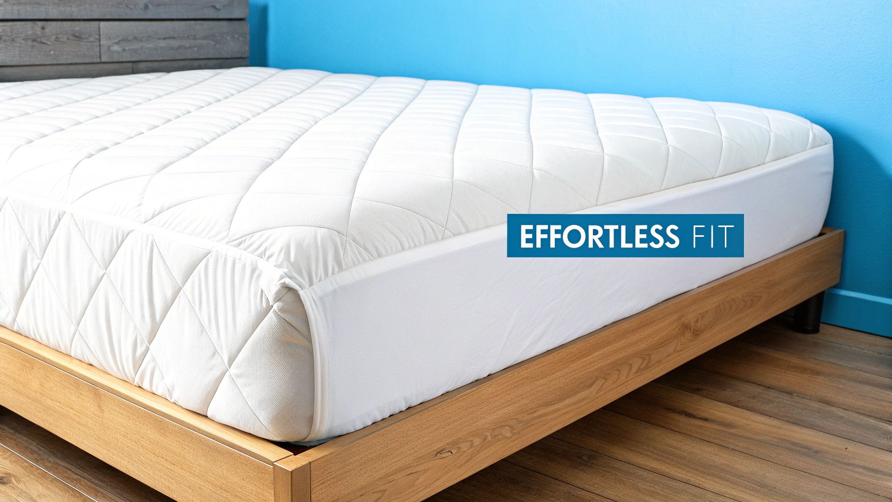 A white quilted mattress pad with deep pockets showing an effortless fit on a modern wooden bed frame.