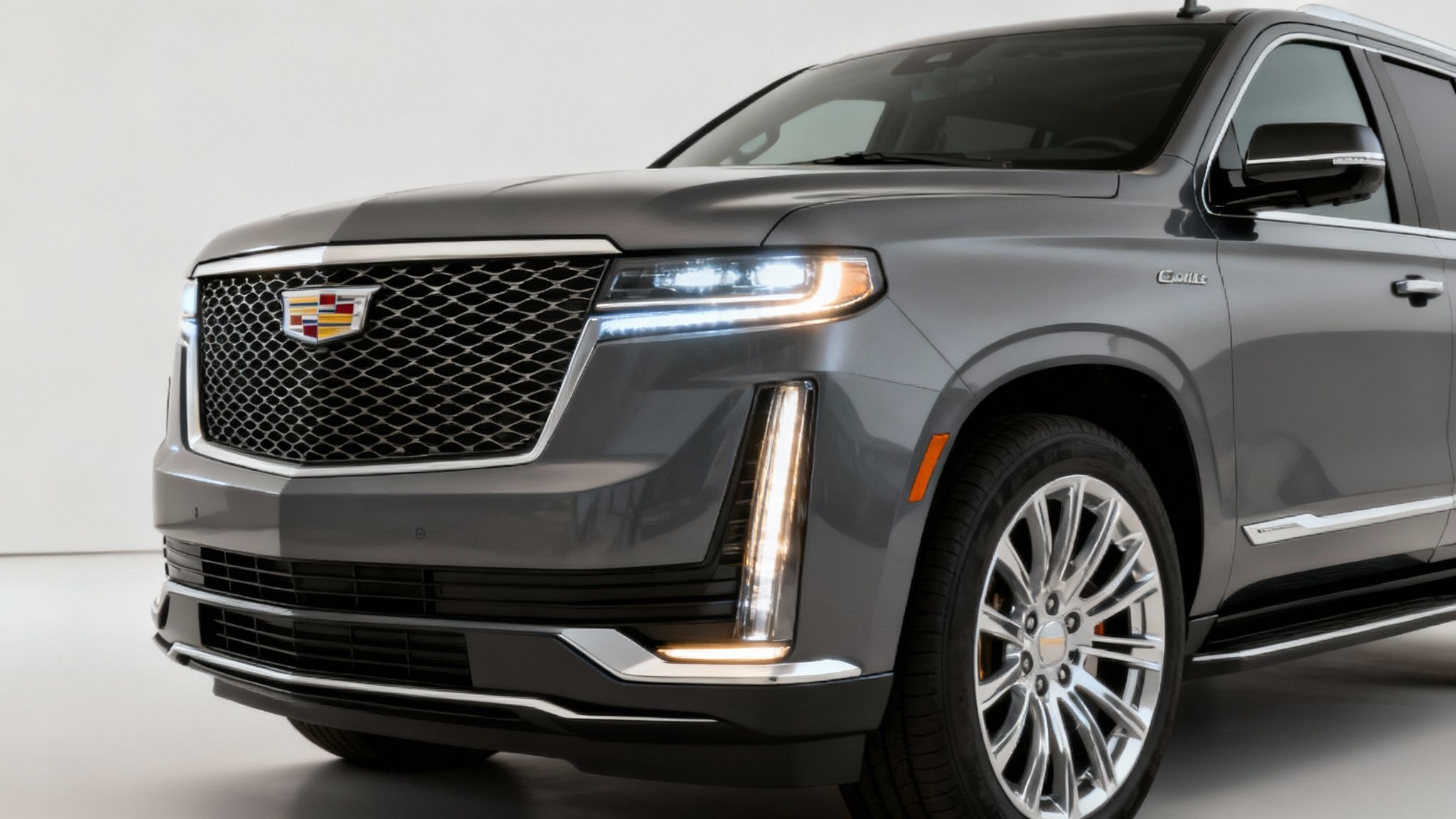 The 2025 Cadillac Escalade's new grille and headlight design shown in a close-up shot.