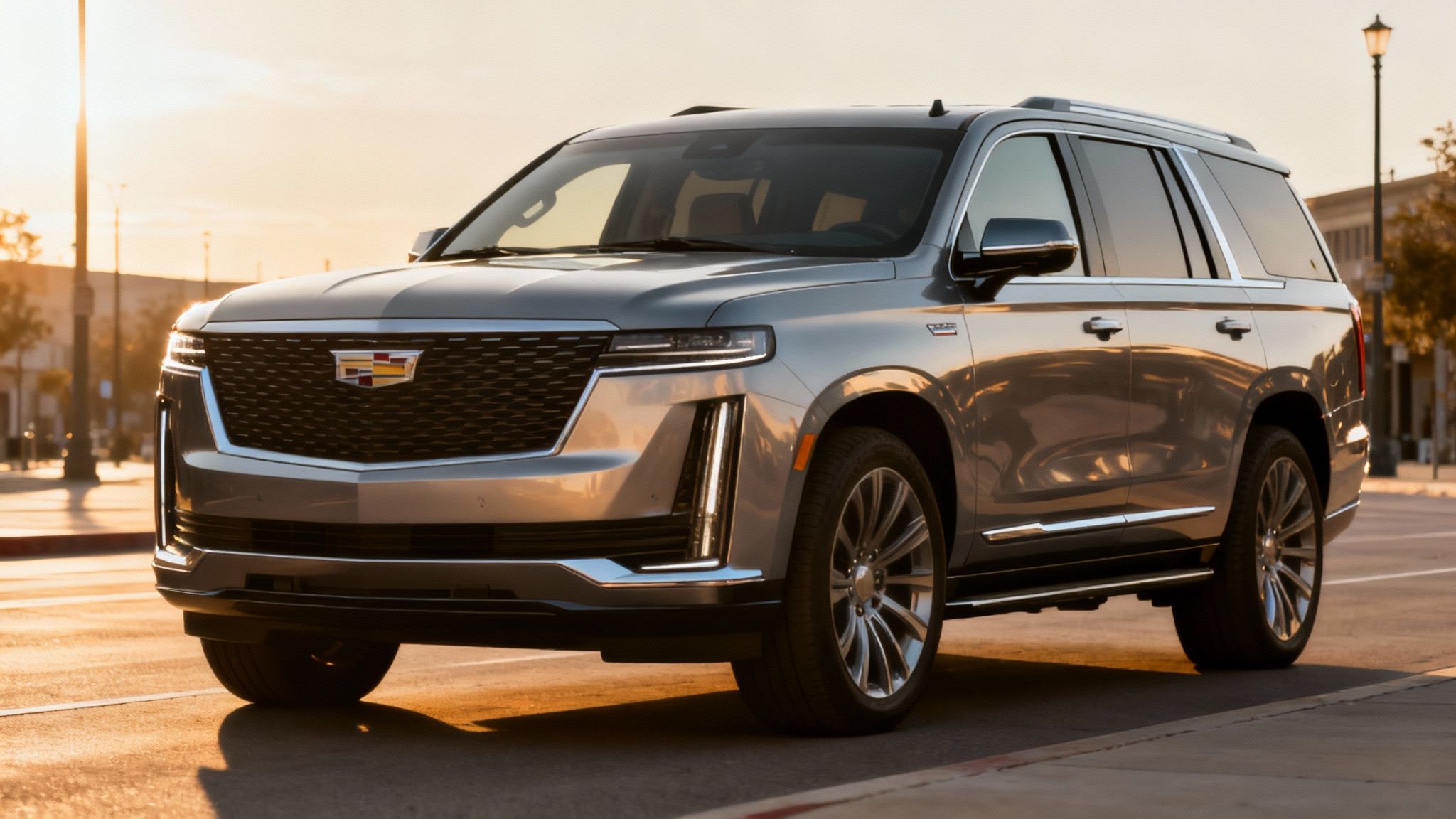 A new 2025 Cadillac Escalade shown from the front three-quarter angle on a modern city street.