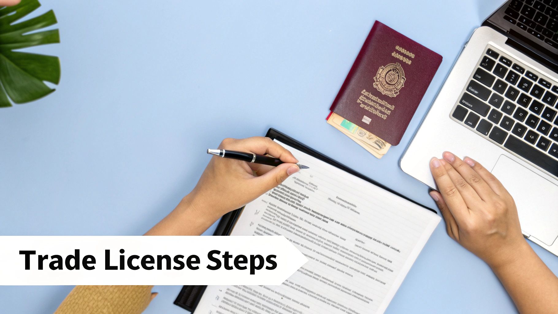 Person filling out a trade license application with a pen, laptop, and passport on a blue desk.