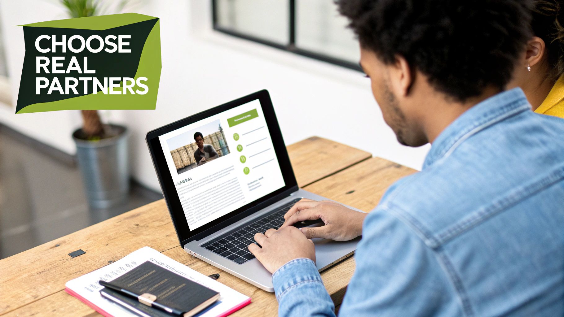 A person uses a laptop on a wooden desk, with a 'CHOOSE REAL PARTNERS' graphic.