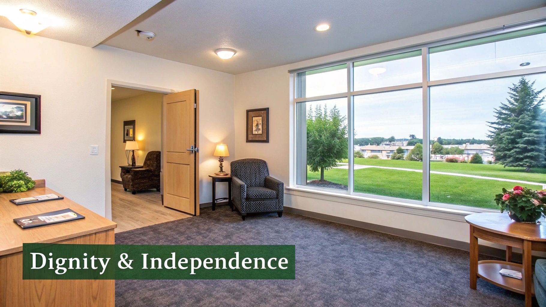 Bright and inviting lounge area in an assisted living facility with large windows overlooking a green lawn.