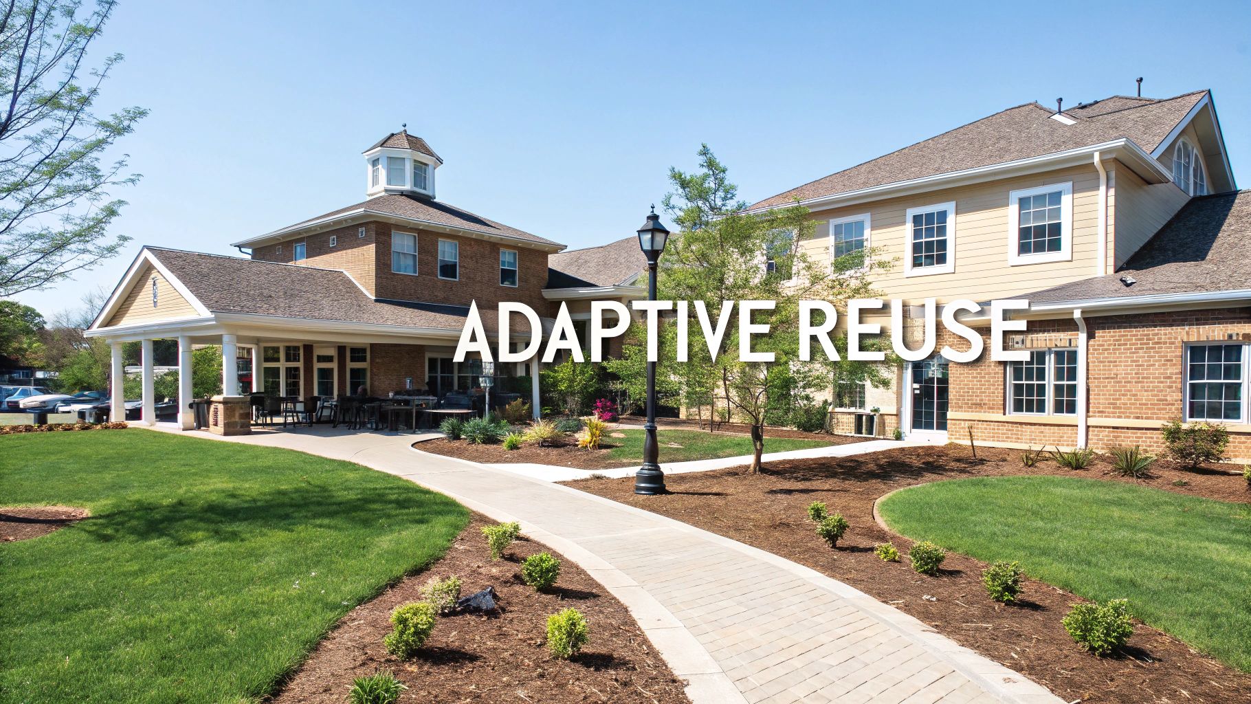 An exterior view of an assisted living facility featuring green lawns and a walkway, with 'ADAPTIVE REUSE' text.