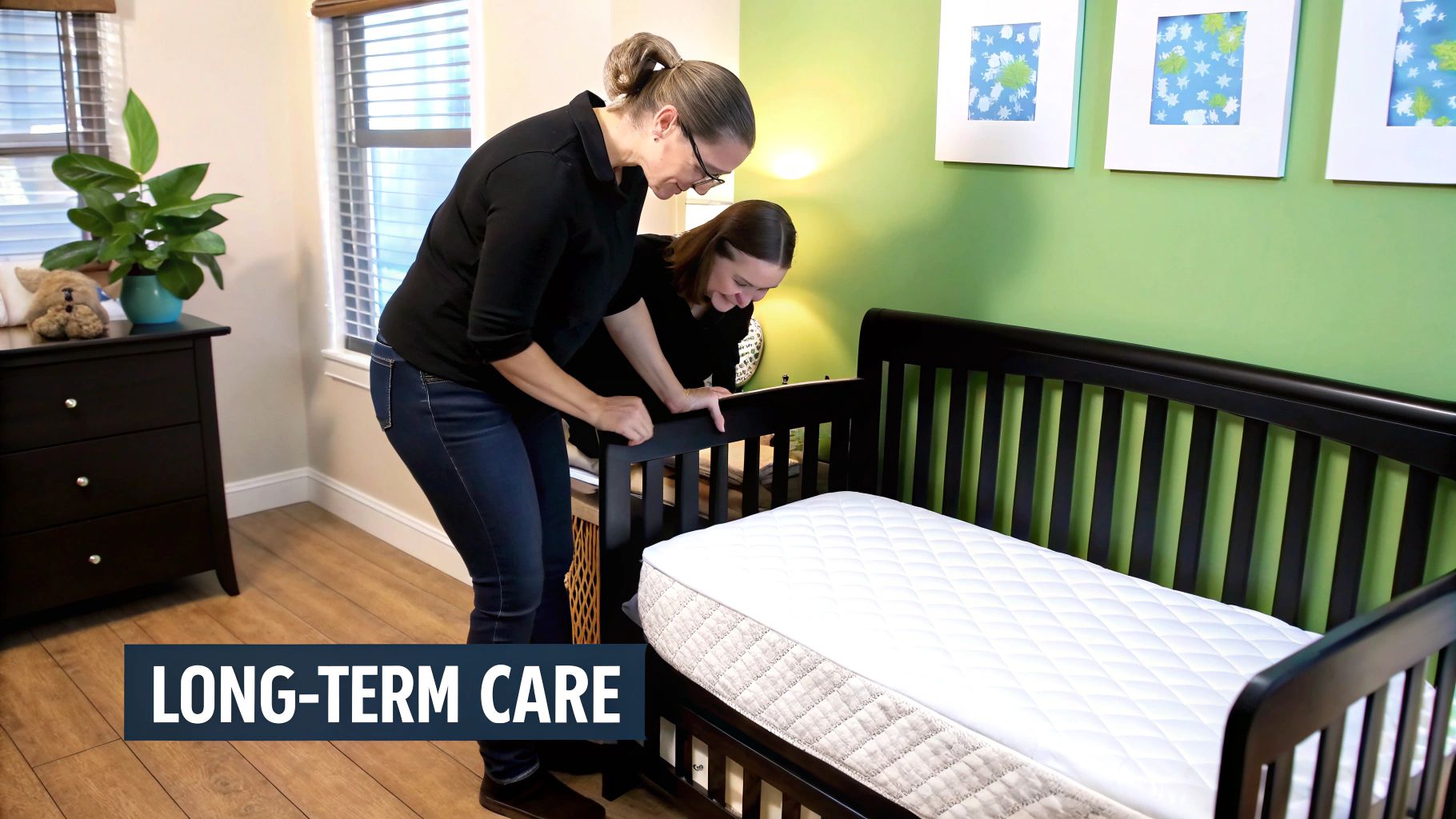 Two women examine a new white mattress in a dark wood crib within a cozy nursery.