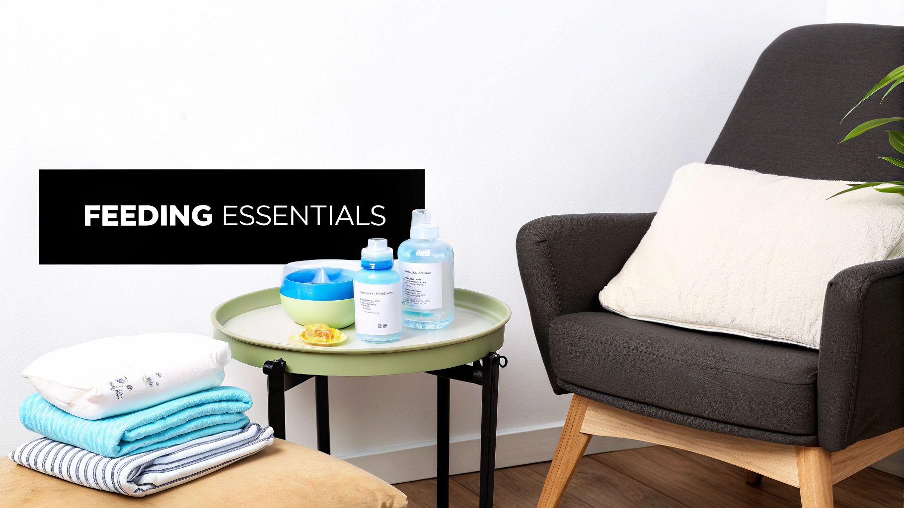 Baby feeding essentials: bottles, bowl, and folded blankets on a side table beside a dark armchair.