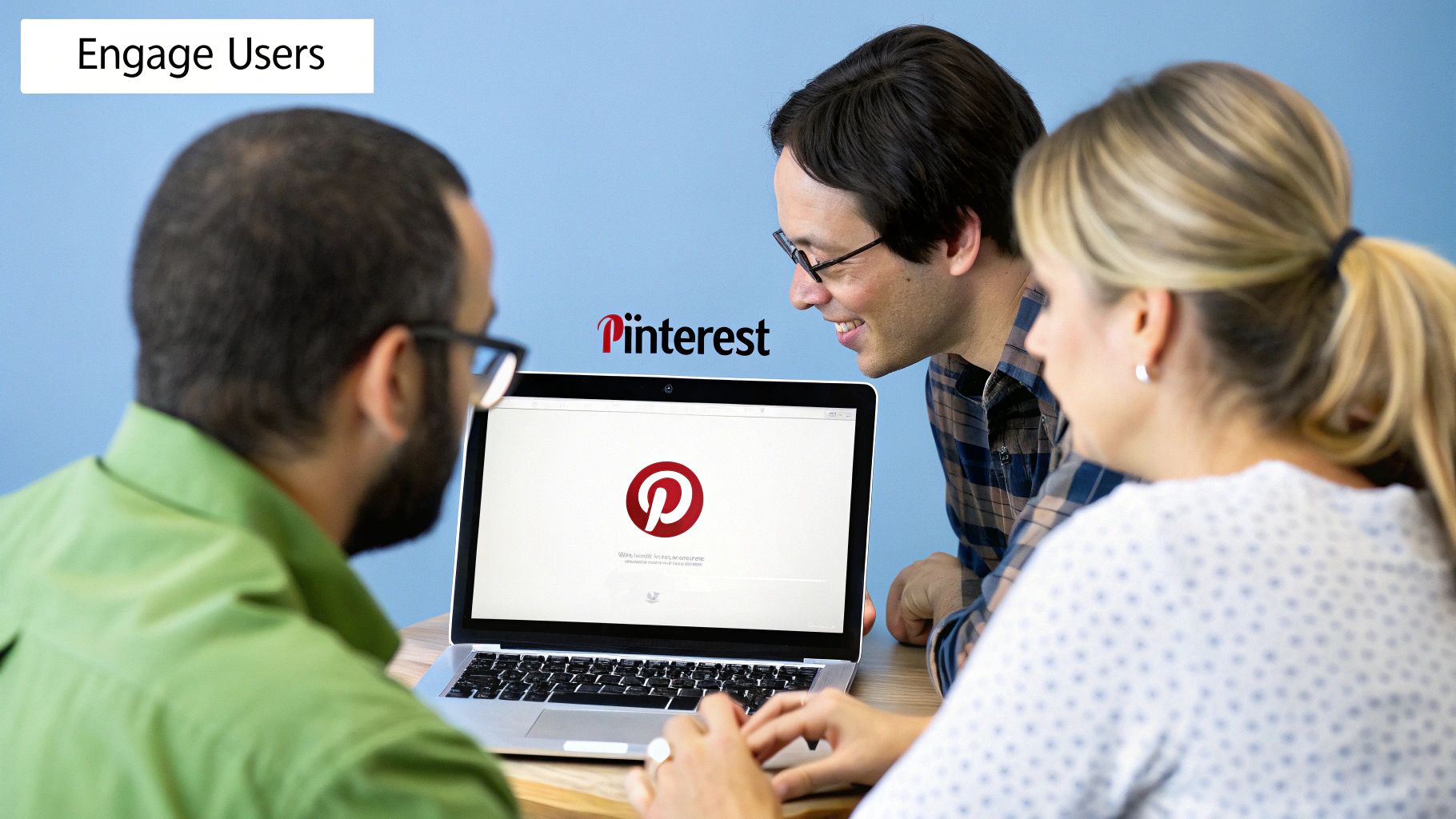 Team collaborating on Pinterest strategy to engage users on laptop screen.