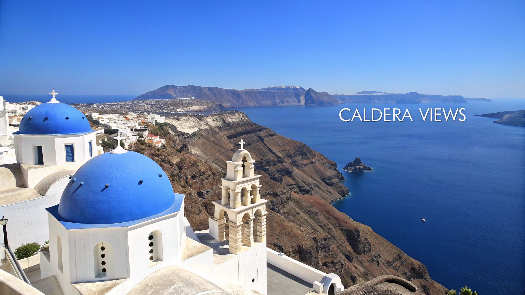 Panoramic view of Santorini, Greece, with blue-domed churches and cliffs overlooking the Aegean Sea caldera.