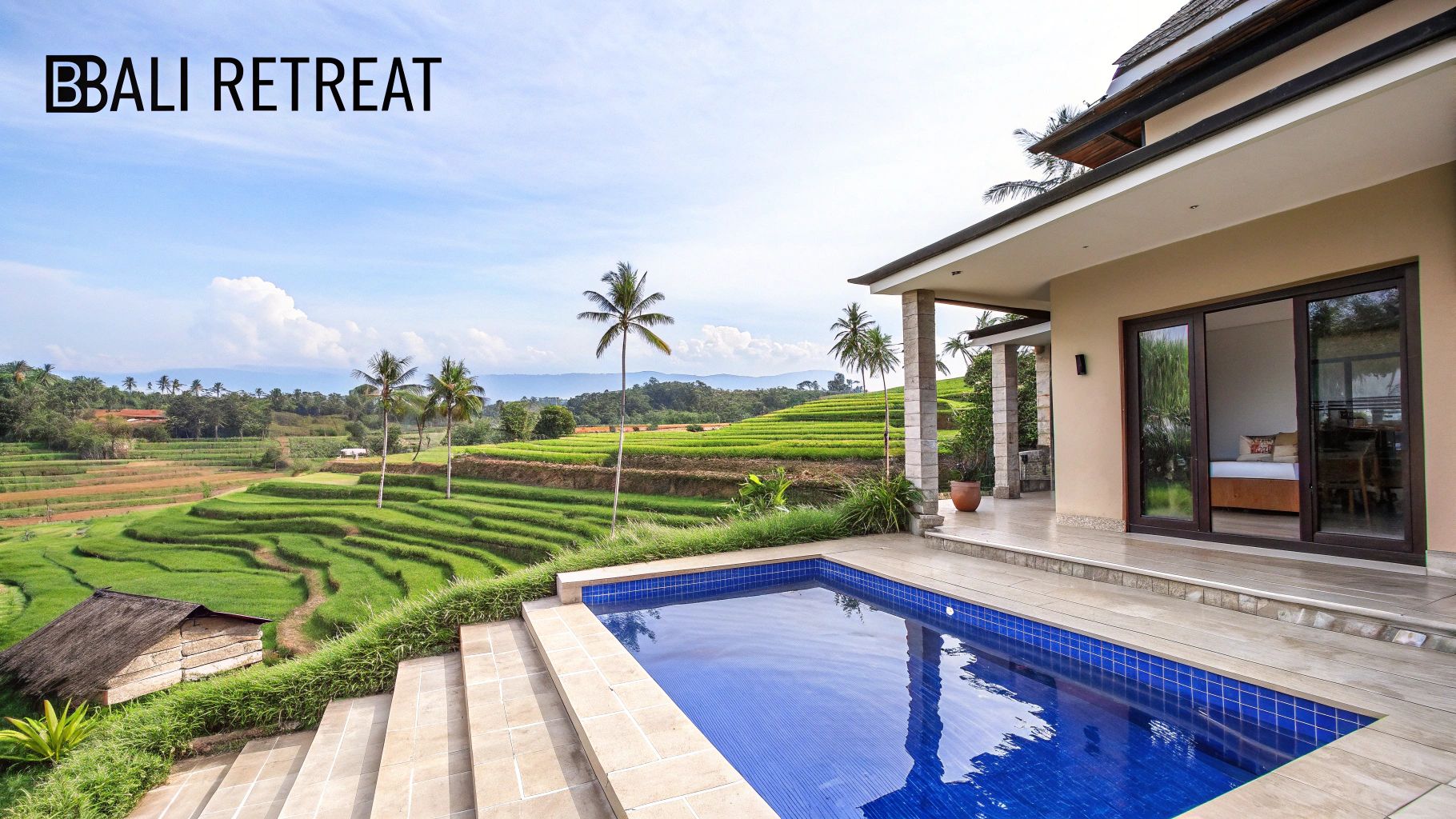 A luxurious Bali villa with a blue swimming pool offering panoramic views of lush green rice terraces.