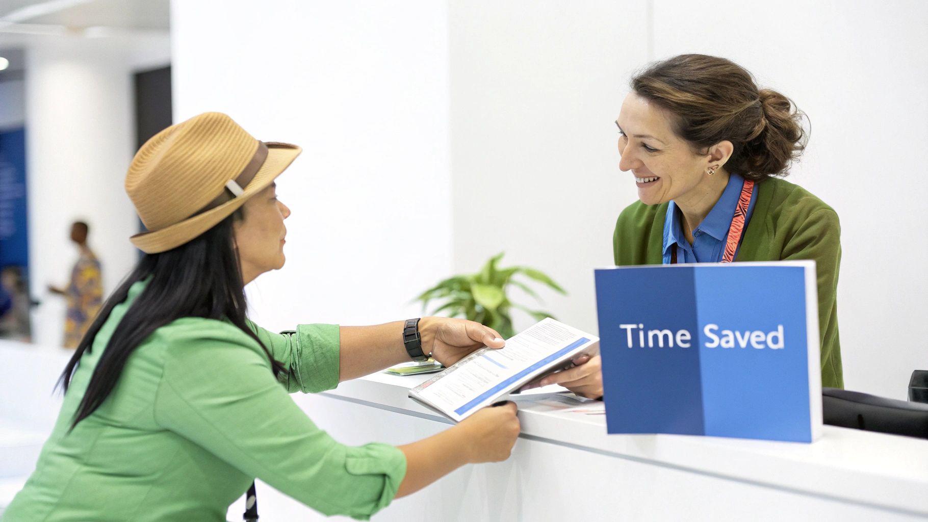 Two women smiling while exchanging documents at a service counter with a 'Time Saved' sign.