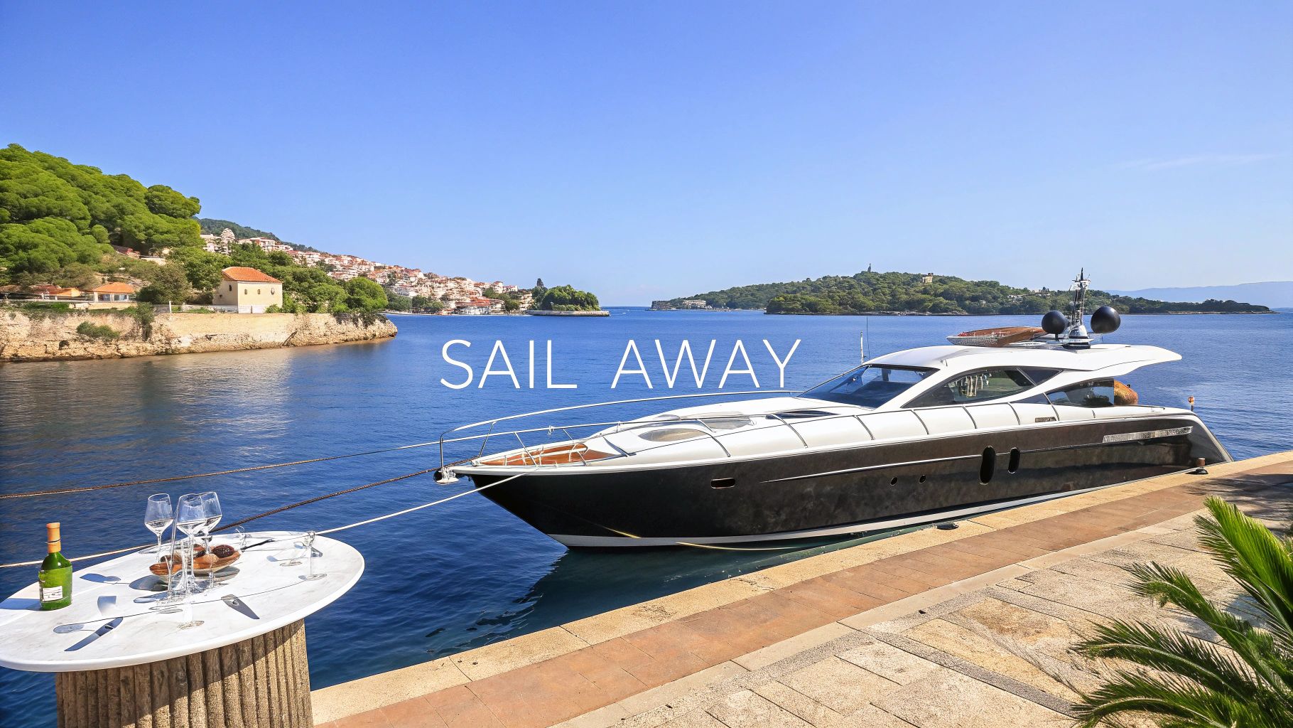 A luxurious yacht docked at a picturesque pier with a coastal town and clear blue sea under a clear sky.