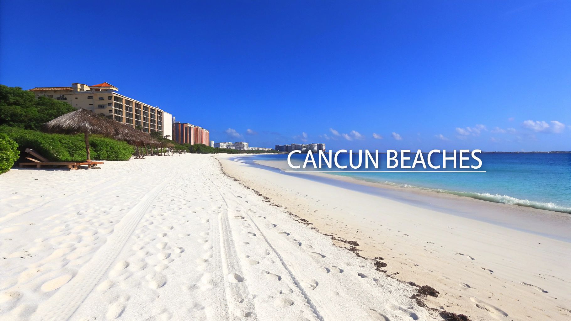 Sunny view of Cancun's white sand beach with clear blue ocean, resort buildings, and palapas.