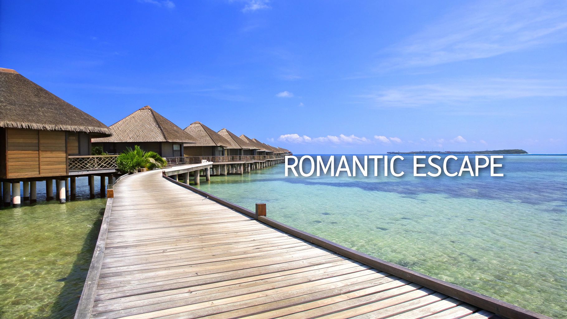 Scenic view of overwater bungalows with thatched roofs connected by a wooden boardwalk over clear turquoise water.