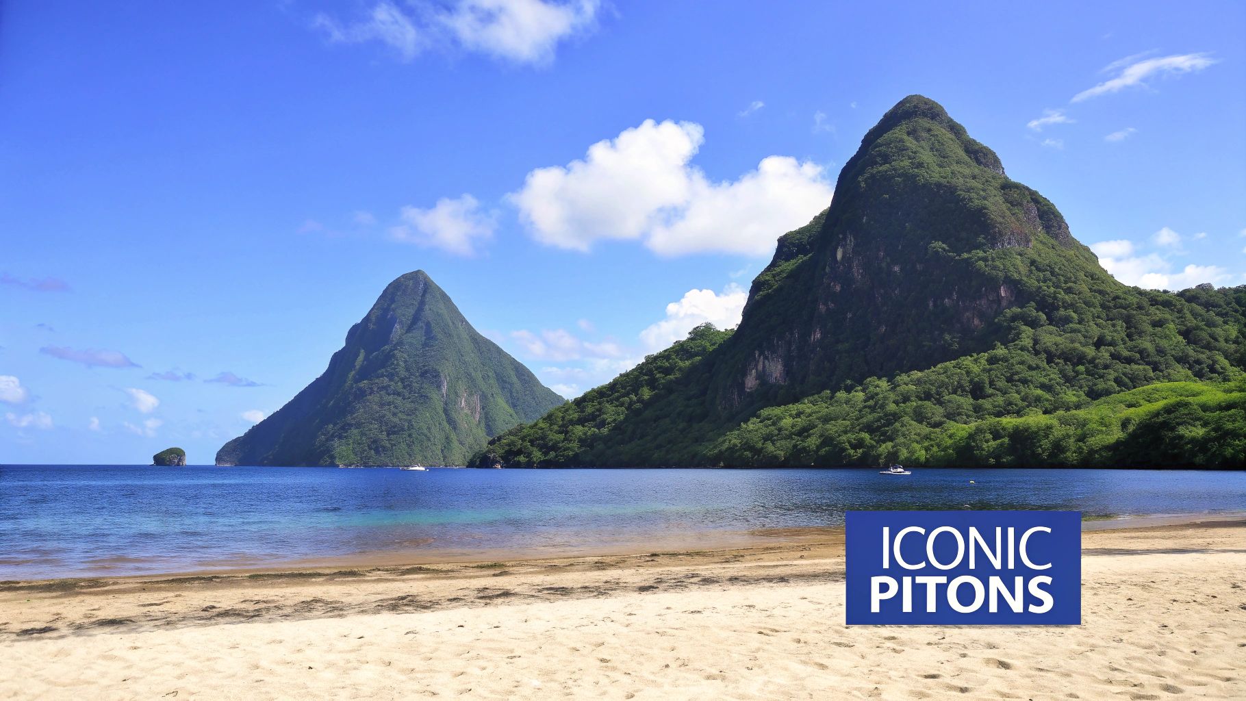 Two dramatic green volcanic pitons rising from turquoise Caribbean waters and sandy beach