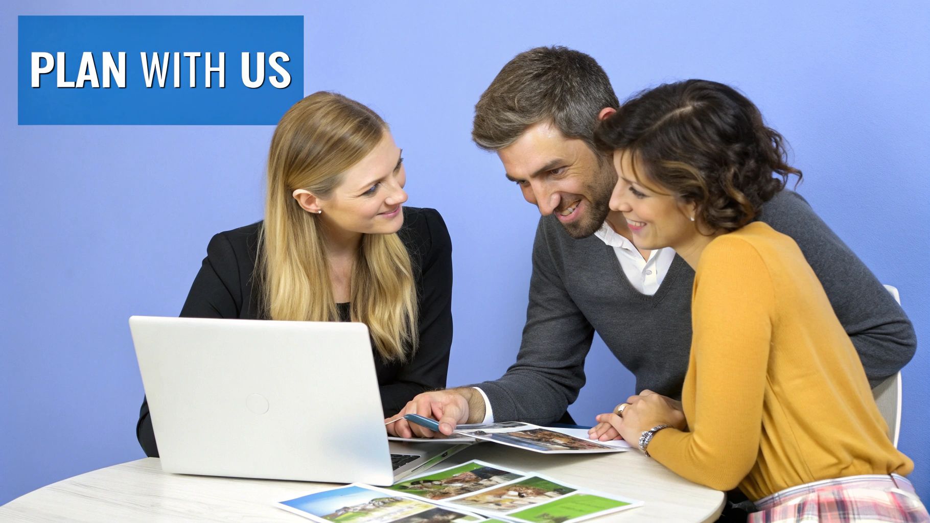 A female agent helps a smiling couple plan their trip, looking at travel brochures and a laptop.