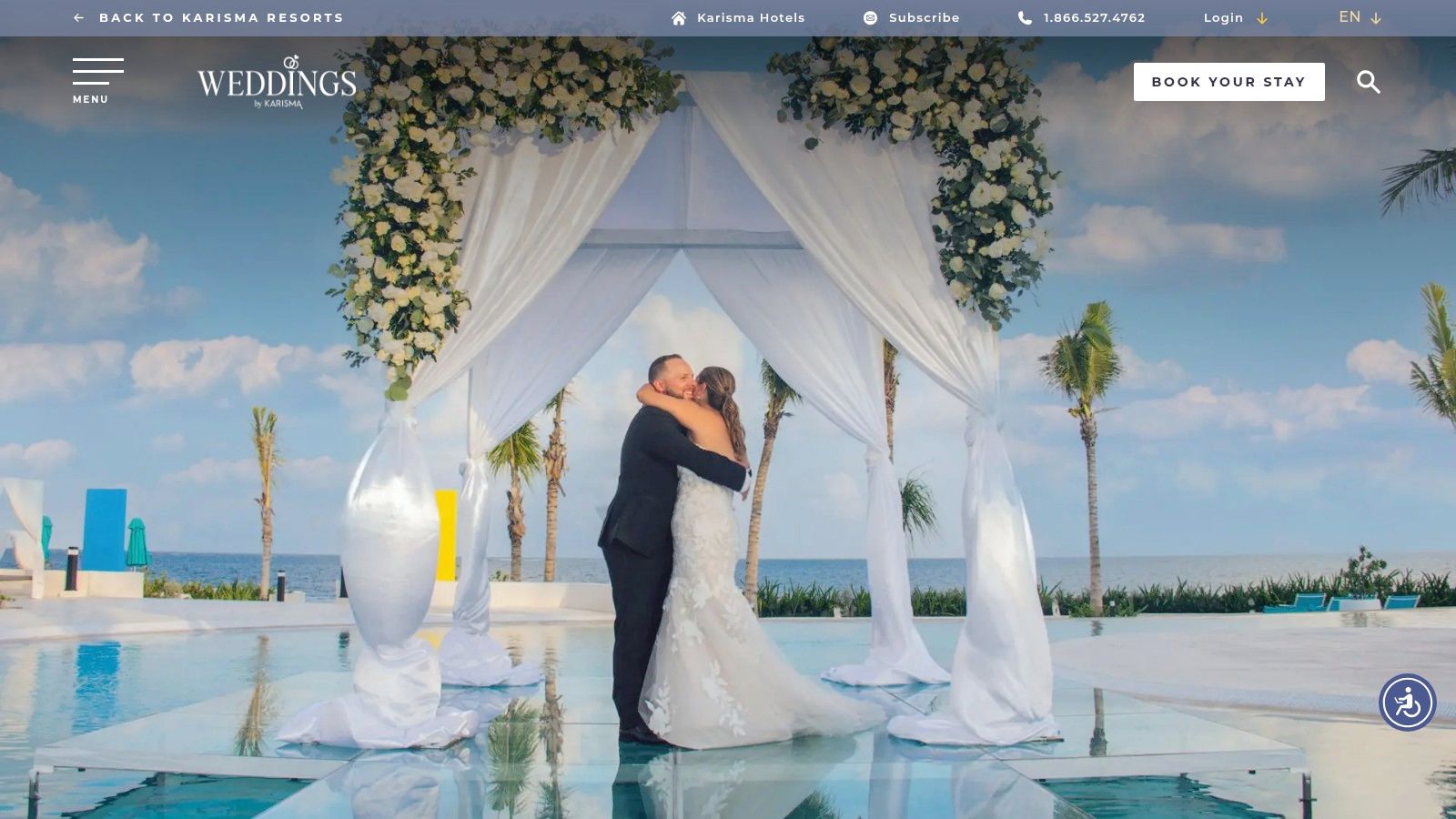 A bride and groom at their wedding ceremony on a sky terrace at a Karisma resort.