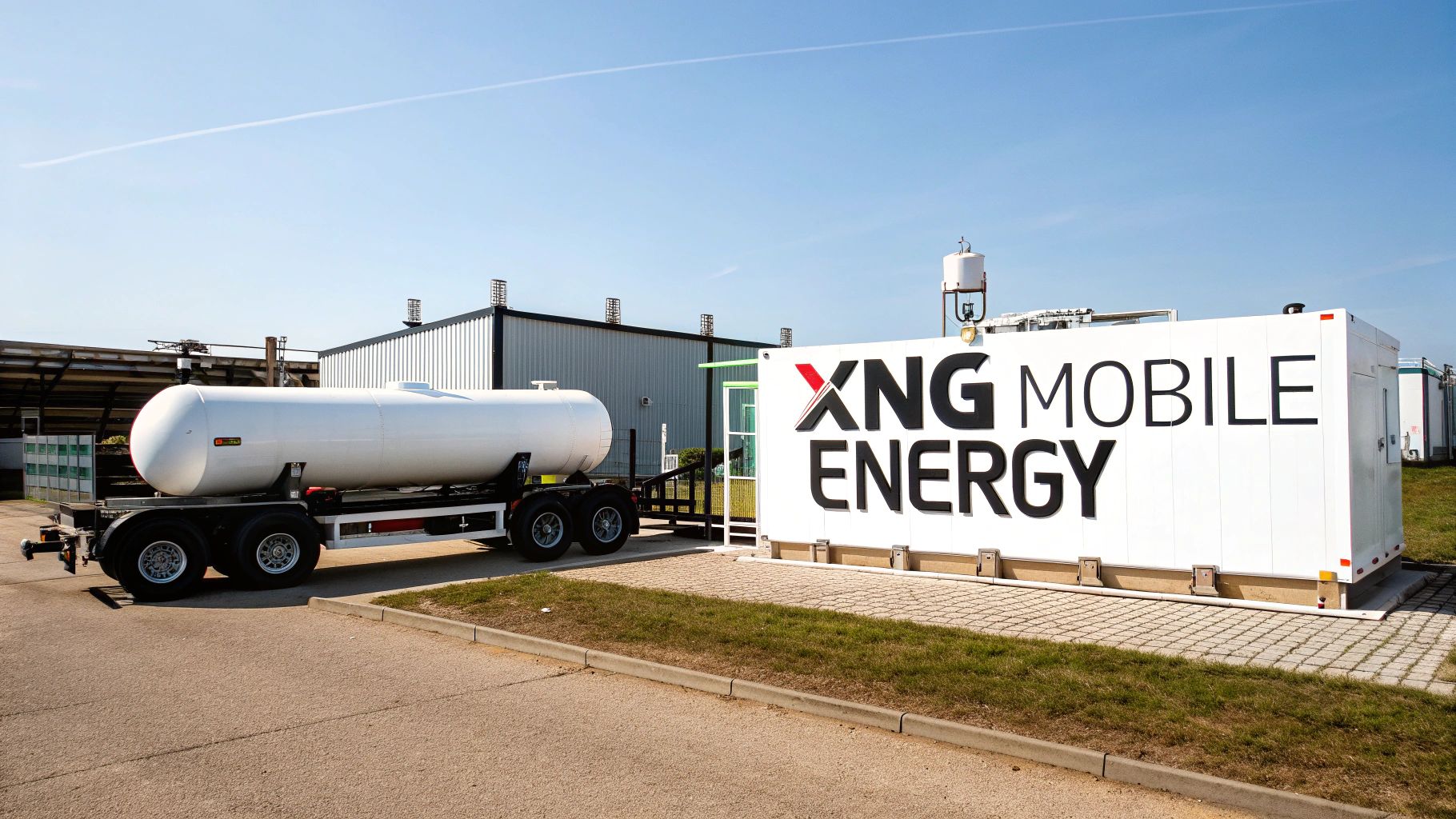 A white tanker truck connected to an 'XNG Mobile Energy' container at an industrial site.
