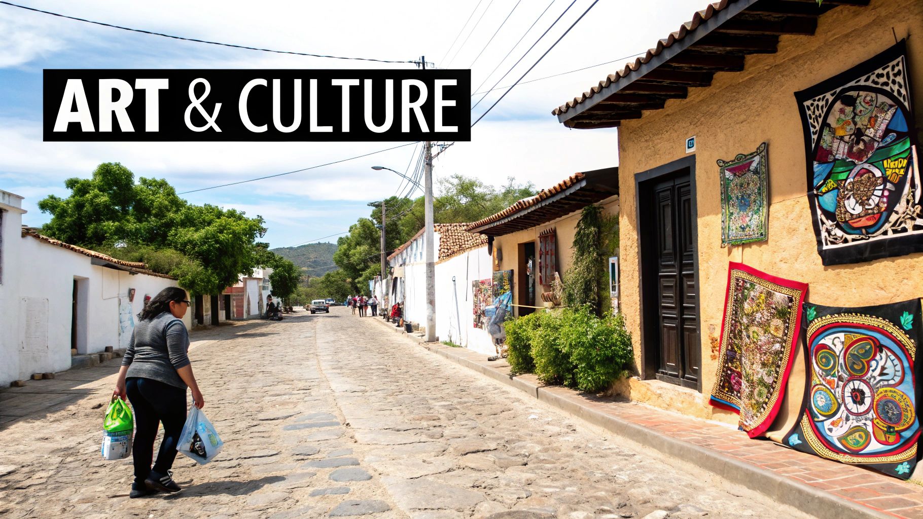 A person walks on a cobblestone street adorned with vibrant art displays and the text 'ART & CULTURE'.