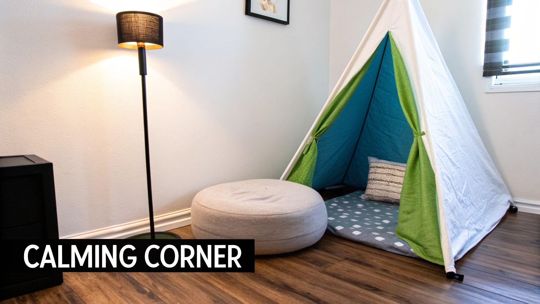 A serene "calming corner" with a white teepee tent, round beige ottoman, and warm floor lamp on a wooden floor.