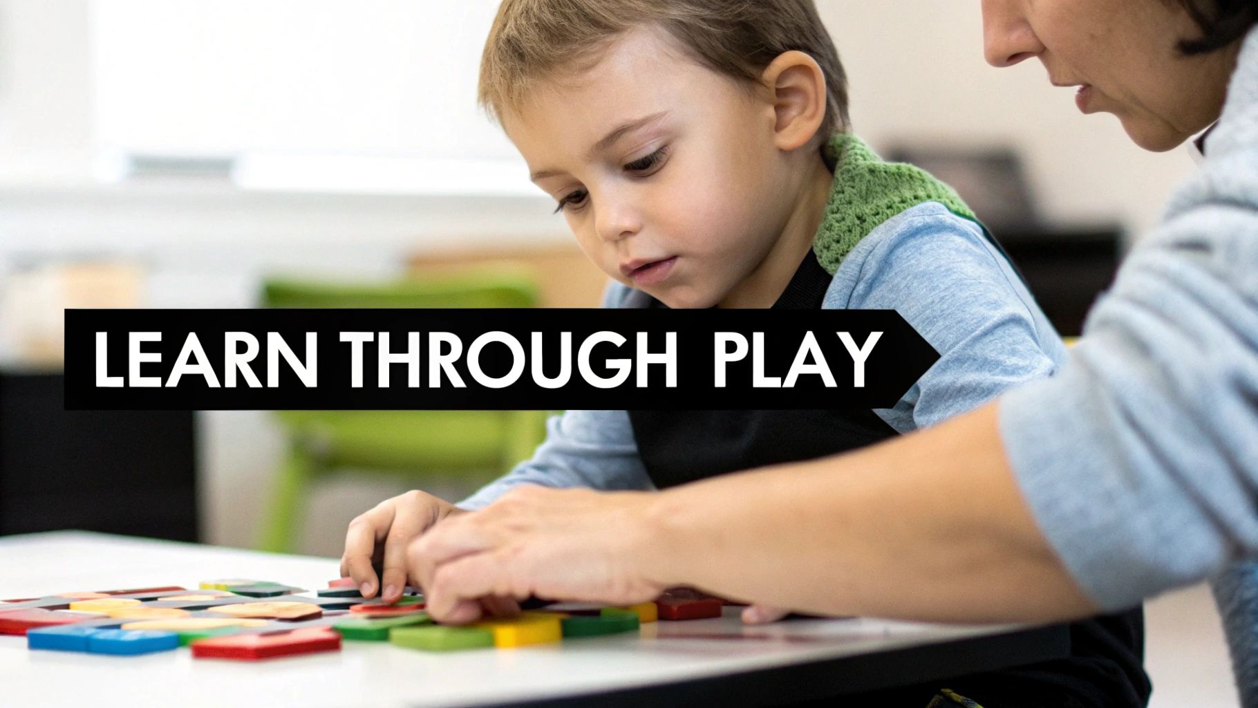 A young child and an adult engage in learning through play with colorful geometric shapes.