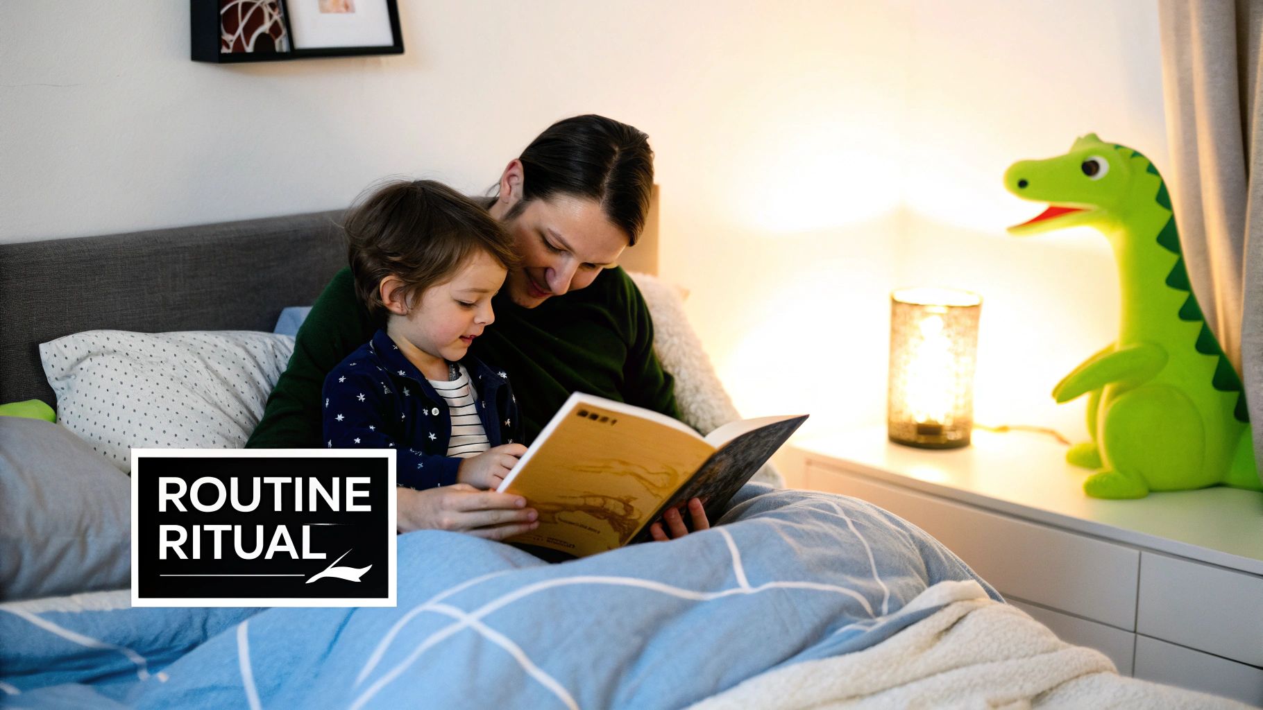 A parent and child read a bedtime story together in bed with a dinosaur night light nearby.