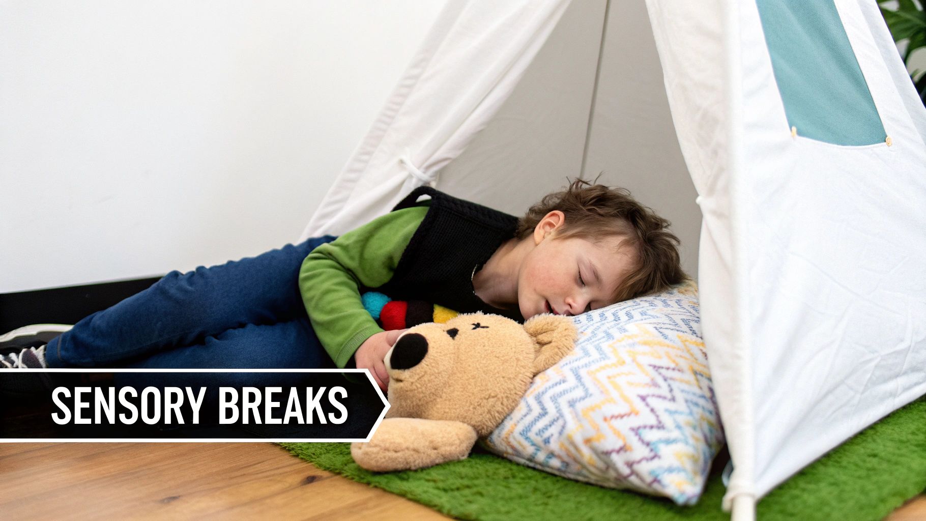 A child peacefully sleeps inside a white tent on a green rug with a teddy bear, taking a sensory break.