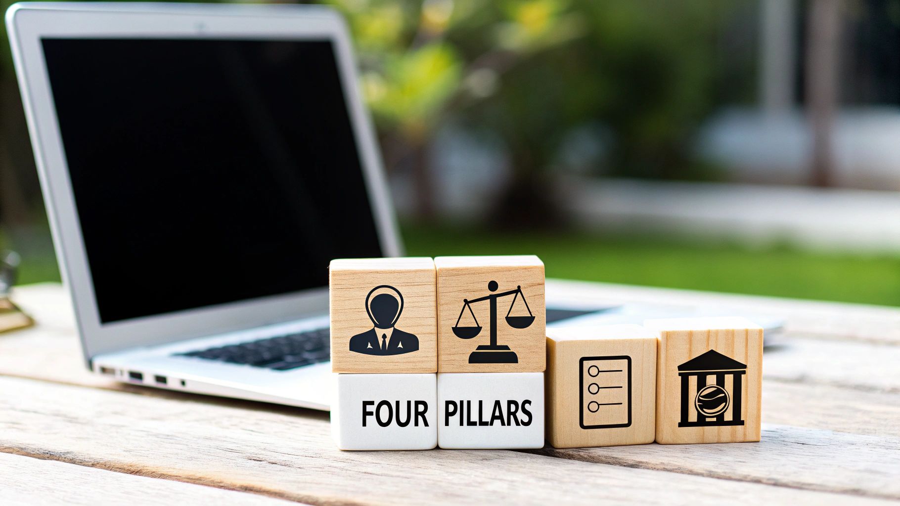 Wooden blocks display 'FOUR PILLARS' with icons for professional, justice, checklist, and institution, beside a laptop.