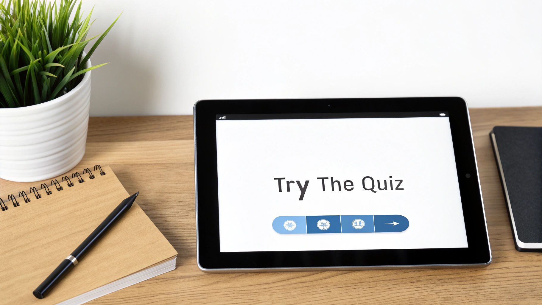 A tablet displaying 'Try The Quiz' with a progress bar, placed on a wooden desk.