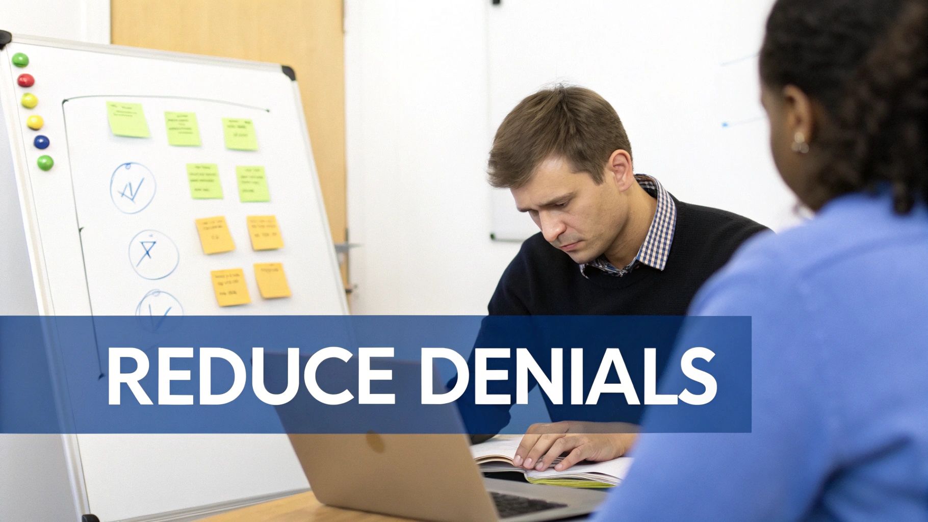 Professionals collaborate in an office, analyzing data on a laptop near a whiteboard, focusing on reducing denials.