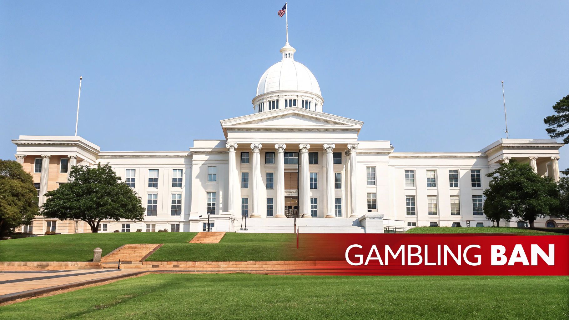 A clear blue sky above the Alabama State Capitol building, featuring a prominent red “GAMBLING BAN” banner.
