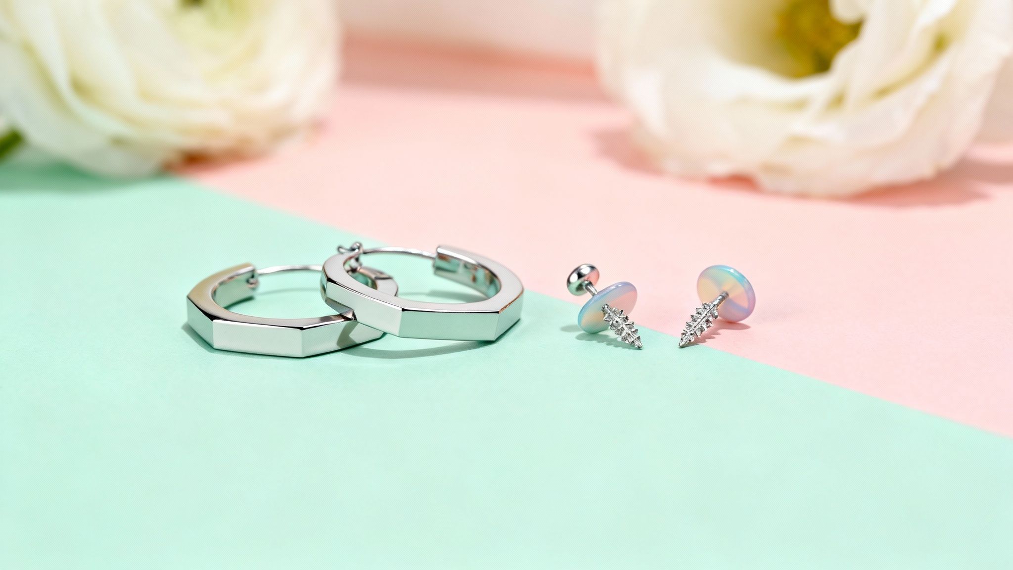 A close-up of a person wearing trendy, modern earrings, with a soft, blurred background.
