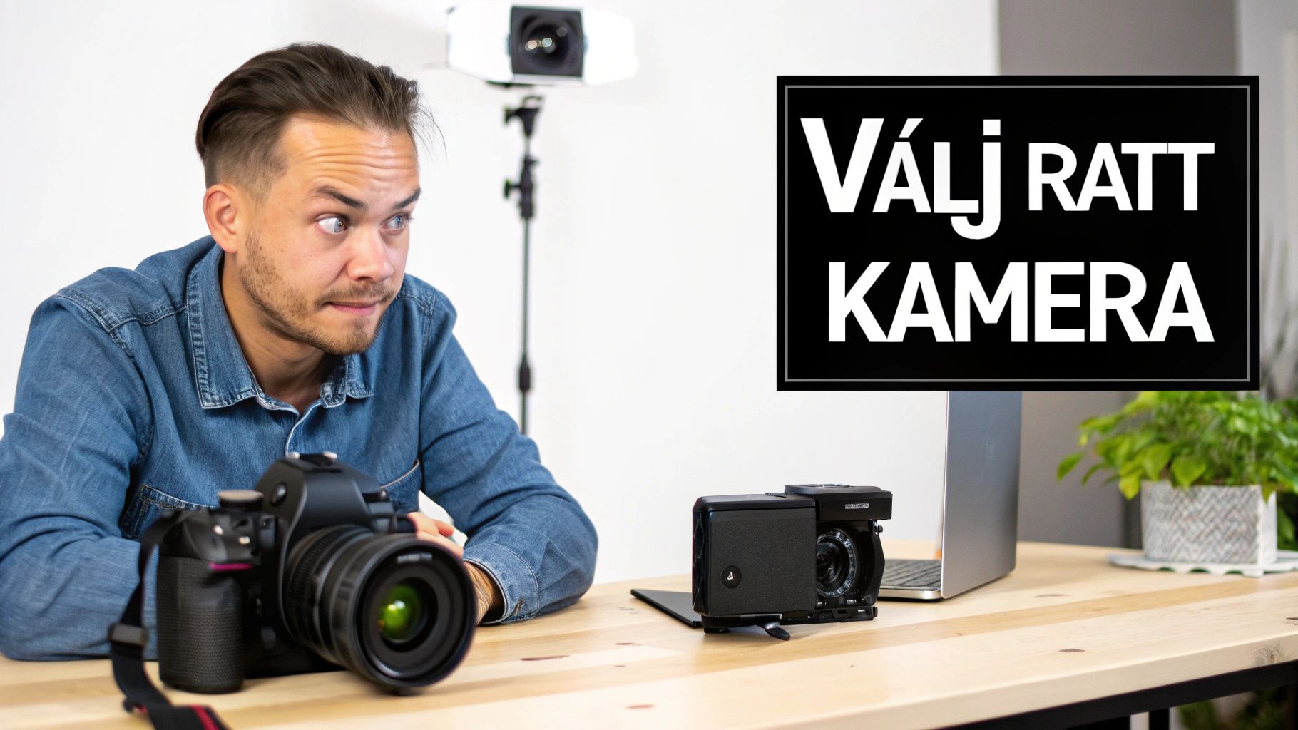 A man with a focused expression sits at a desk with two cameras and studio lighting.