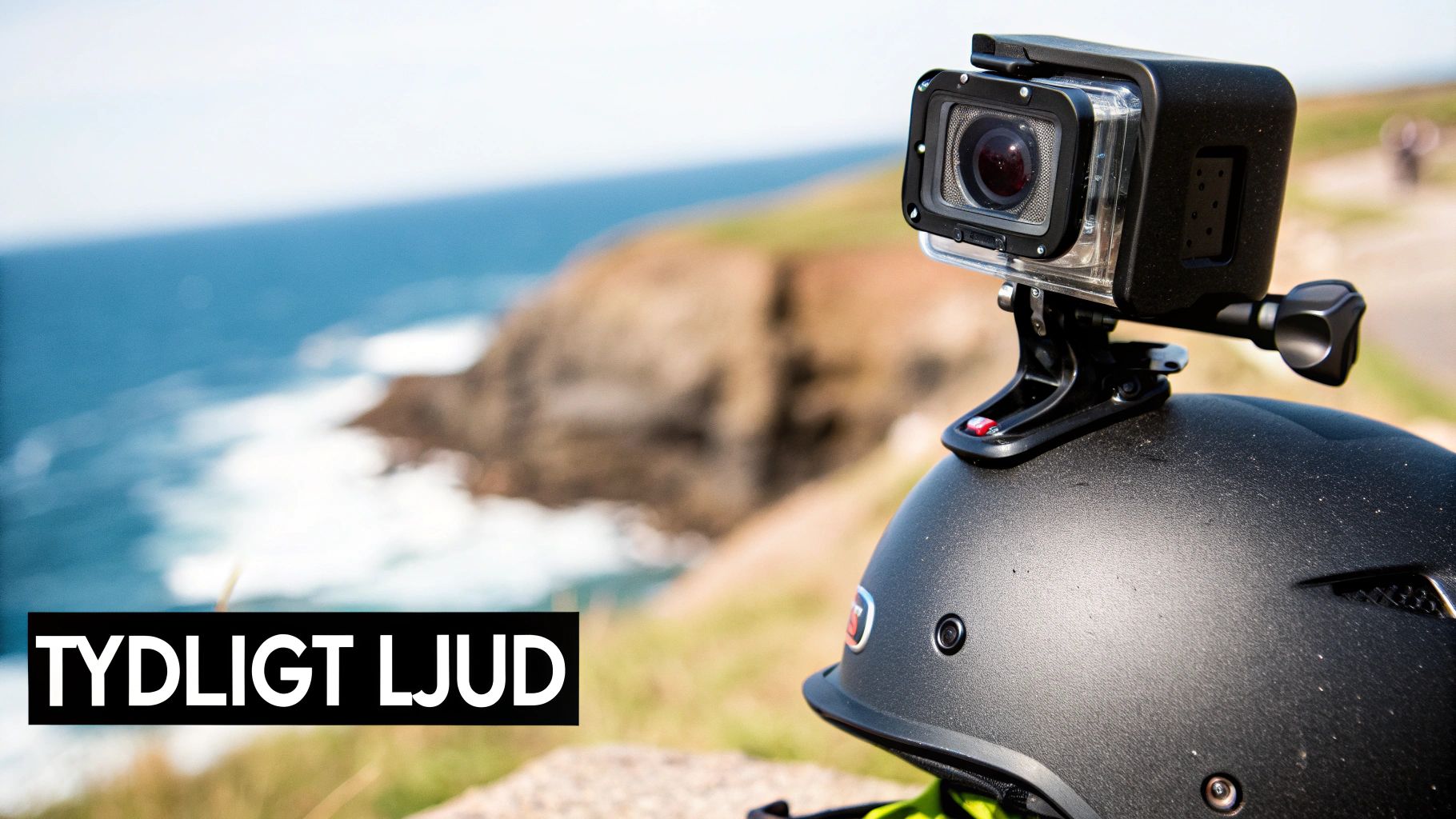 A GoPro camera mounted on a black helmet with a scenic coastline and ocean in the background. The text "CLEAR AUDIO" is overlaid.